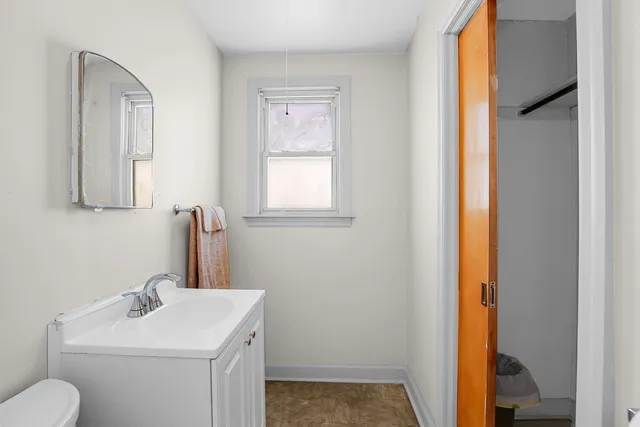 a bathroom with a toilet sink and mirror
