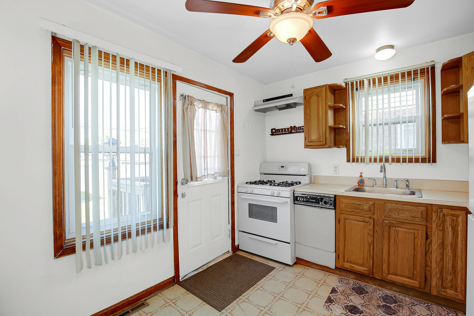 10922 South Ave B Chicago, IL 60617 - Photo 7 of 24 a kitchen with a sink stove and cabinets
