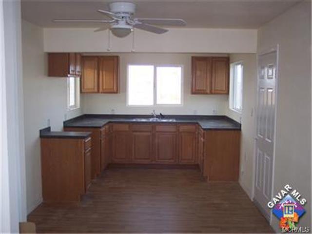 44727 Graphic Street Lancaster, CA 93535 - Photo 4 of 5 a kitchen with granite countertop a sink cabinets and window