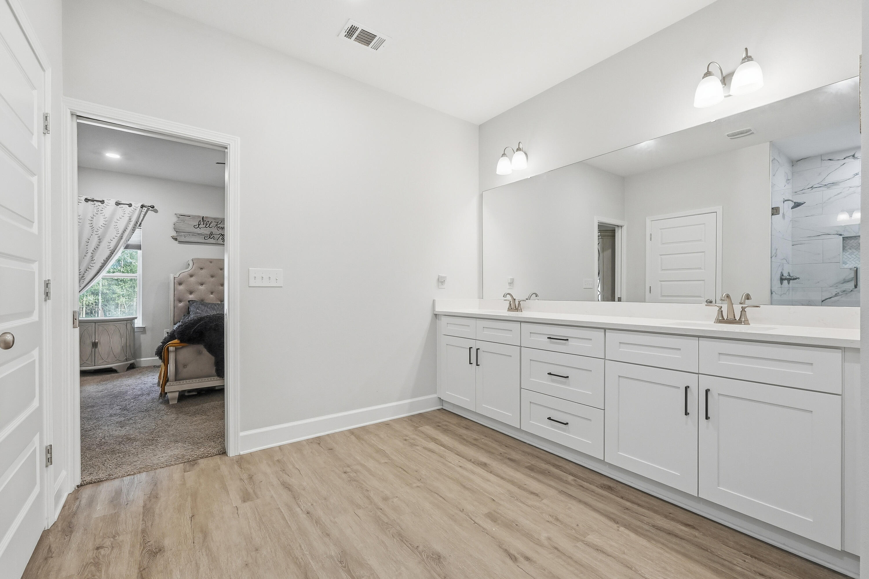 5833 La Porte Road Crestview, FL 32539 - Photo 32 of 44 a spacious bathroom with a double vanity sink and a mirror
