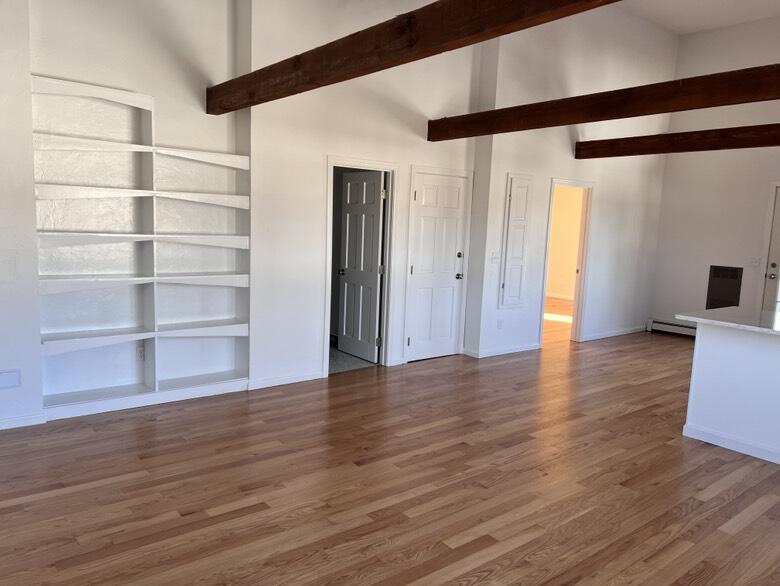 237 Route 28, Unit 2 West Harwich, MA 02671 - Photo 1 of 11 a view of an empty room with wooden floor and a window
