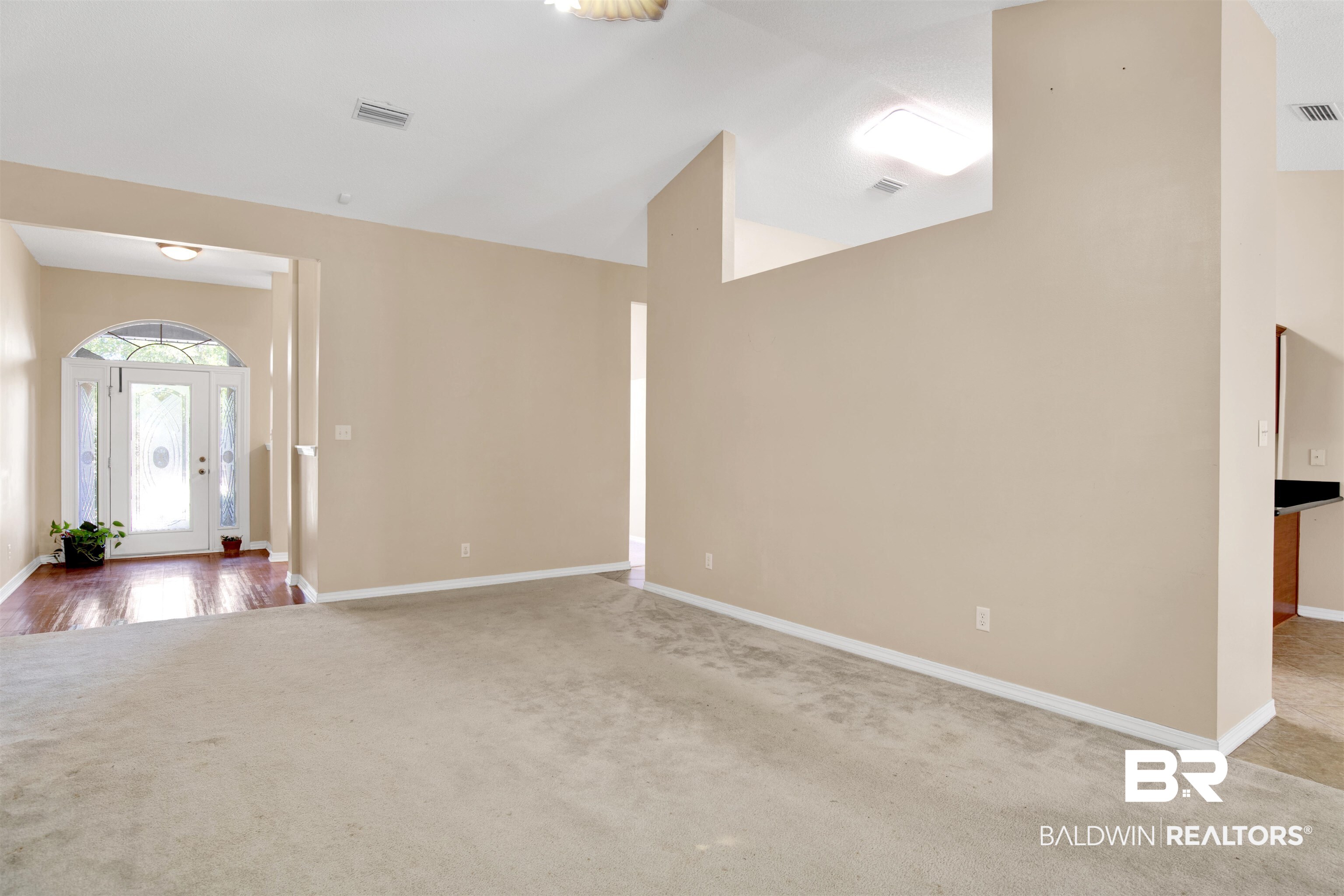 7297 Bridgemill Drive Mobile, AL 36619 - Photo 6 of 33 Carpeted empty room featuring baseboards and lofted ceiling