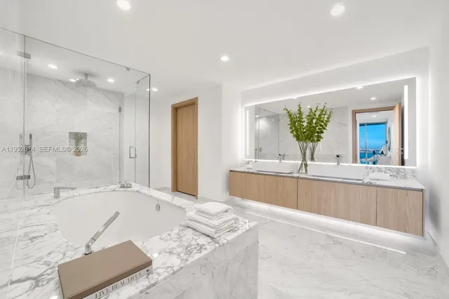 a large spacious bathroom with a large tub shower and sink