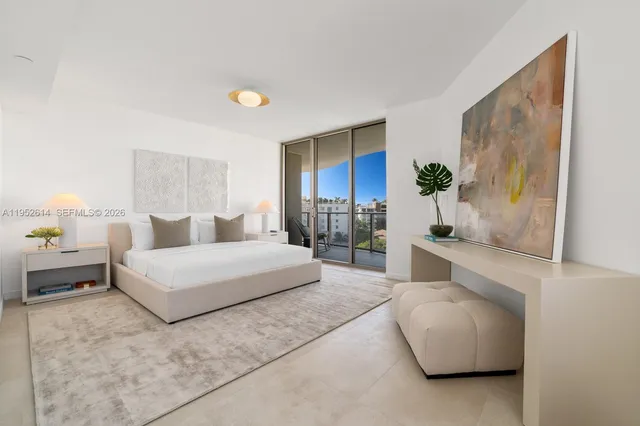 a spacious bedroom with a bed and a couch