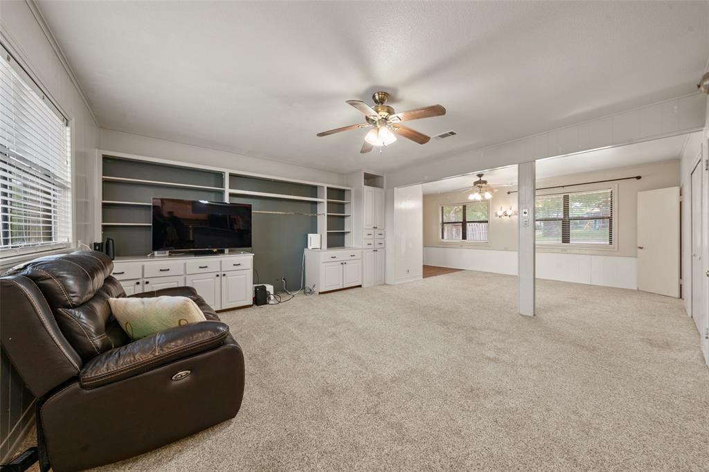 608 West Spring Street West, TX 76691 - Photo 2 of 27 a living room with furniture ceiling fan and a flat screen tv