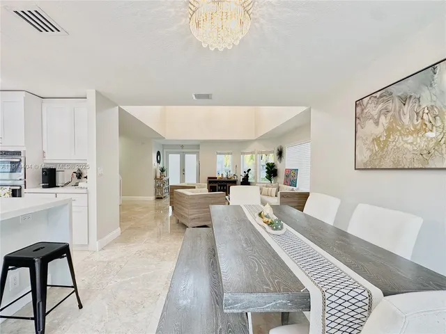 a living room with furniture a fireplace and a table