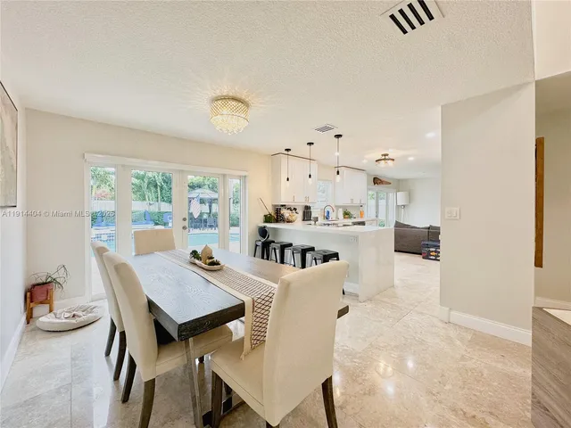 a living room with kitchen island furniture and a table