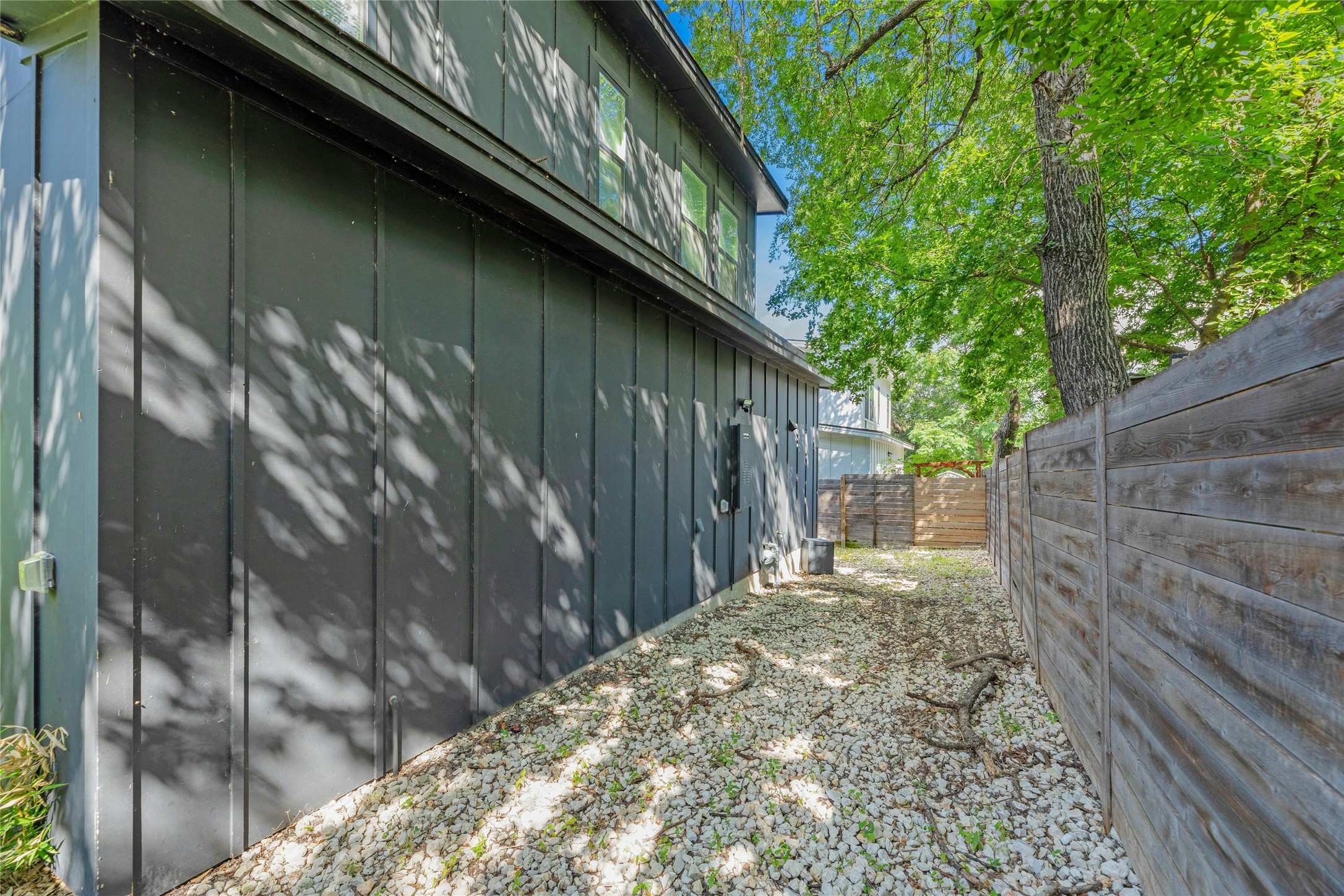 4606 Ledesma Road, Unit 2 Austin, TX 78721 - Photo 27 of 33 A well-maintained side yard features a sturdy wooden fence and ample space for outdoor enjoyment.