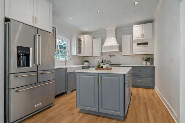 a kitchen with a sink cabinets stainless steel appliances and a window