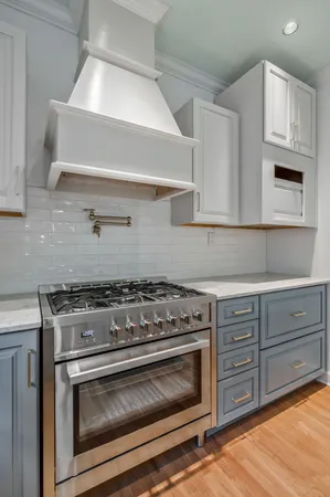 a stove top oven sitting inside of a kitchen