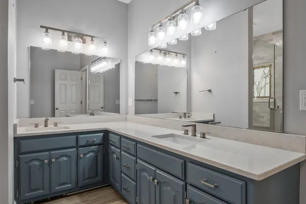 a bathroom with a sink double vanity and a mirror