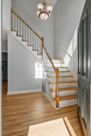 a view of entryway and hall with wooden floor