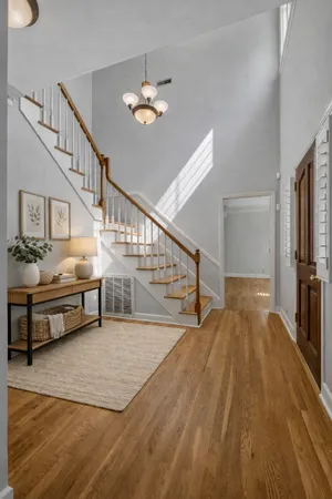 a view of entryway and hall with wooden floor