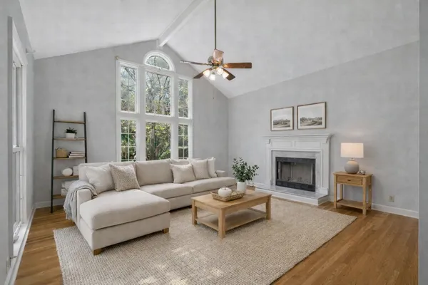 a living room with furniture a chandelier and a fireplace