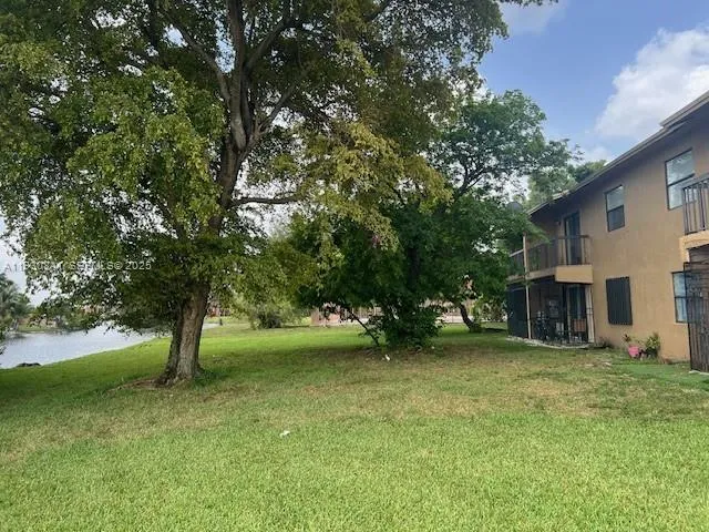a view of a tree in front of a house