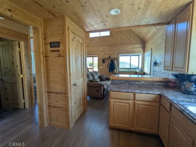 a spacious bathroom with a granite countertop sink a mirror and shower