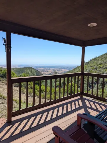 a view of a balcony with wooden floor