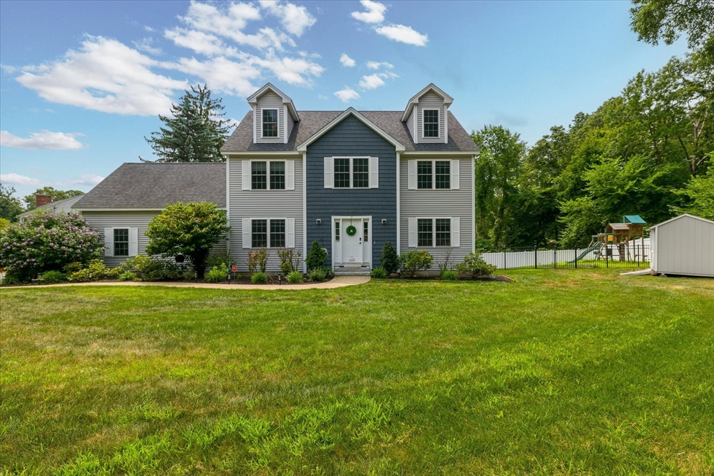 a front view of house with yard and green space