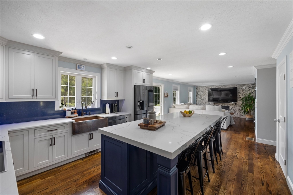 7 Beaman Lane Marlborough, MA 01752 - Photo 11 of 42 a kitchen with stainless steel appliances granite countertop a stove a sink a refrigerator and a dining table with white cabinets