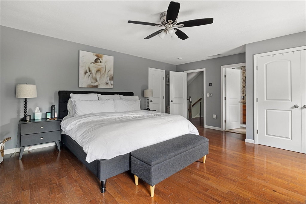 7 Beaman Lane Marlborough, MA 01752 - Photo 18 of 42 a bedroom with a bed and a chandelier