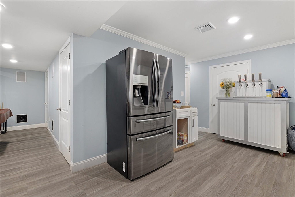 7 Beaman Lane Marlborough, MA 01752 - Photo 32 of 42 a kitchen with stainless steel appliances a refrigerator and wooden floor