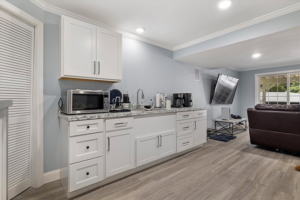 7 Beaman Lane Marlborough, MA 01752 - Photo 33 of 42 a kitchen with white cabinets and stainless steel appliances