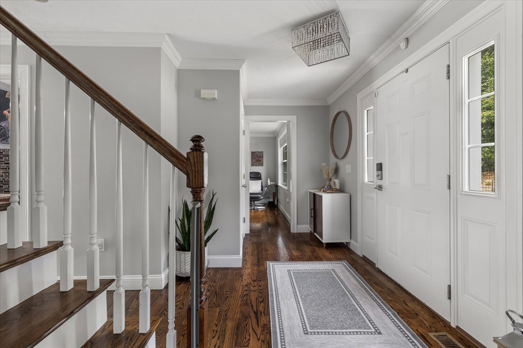 7 Beaman Lane Marlborough, MA 01752 - Photo 4 of 42 a view of a hallway with wooden floor and staircase
