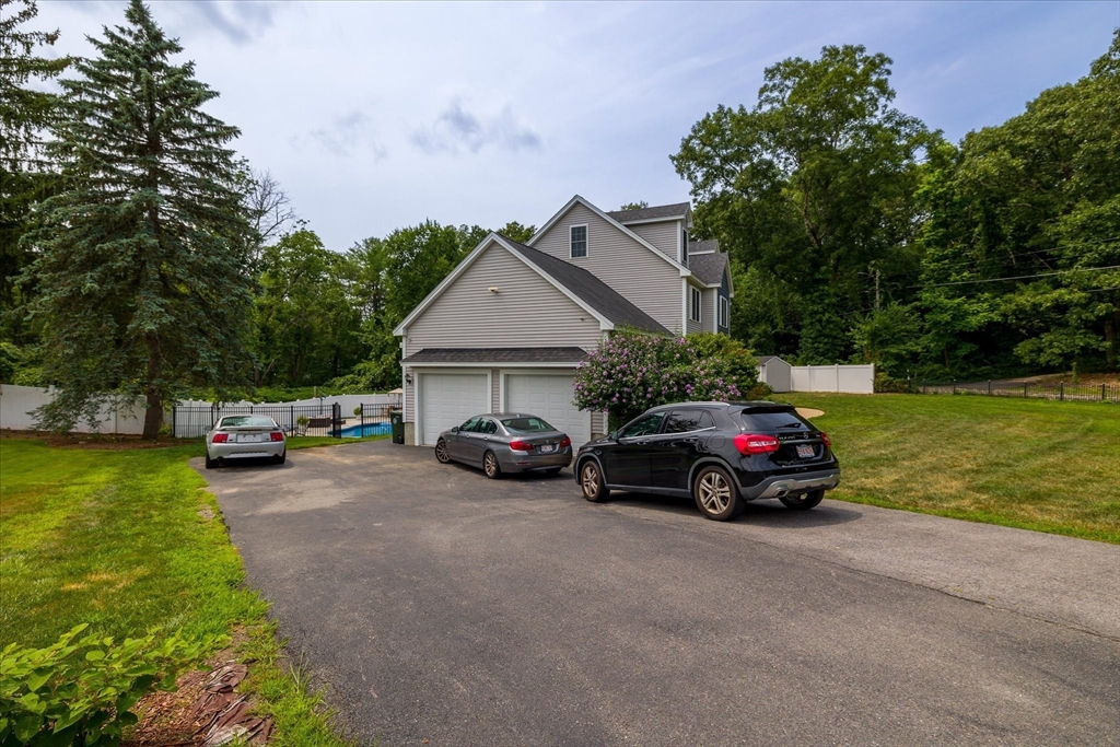 7 Beaman Lane Marlborough, MA 01752 - Photo 41 of 42 a car parked in front of a house with a yard