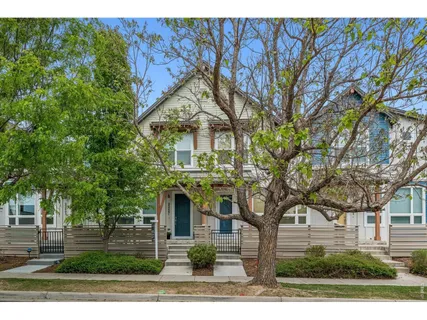 front view of a house with a tree