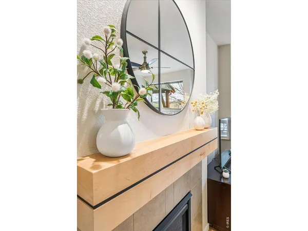 a bathroom with a sink a mirror and a potted plant