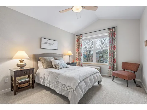 a bedroom with a bed and a lamp