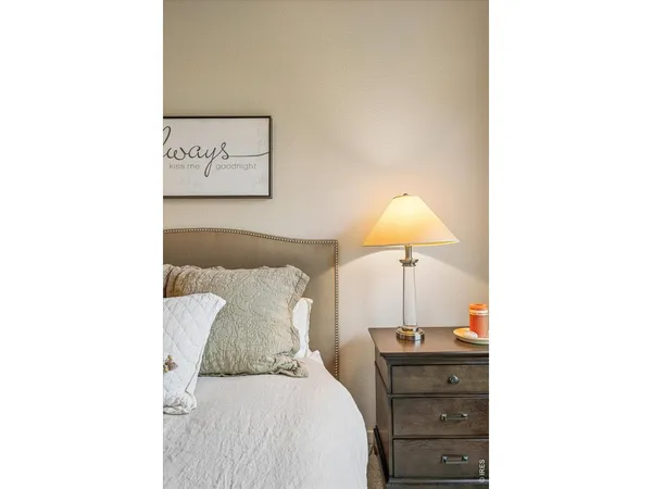 a bedroom with a bed and a lamp
