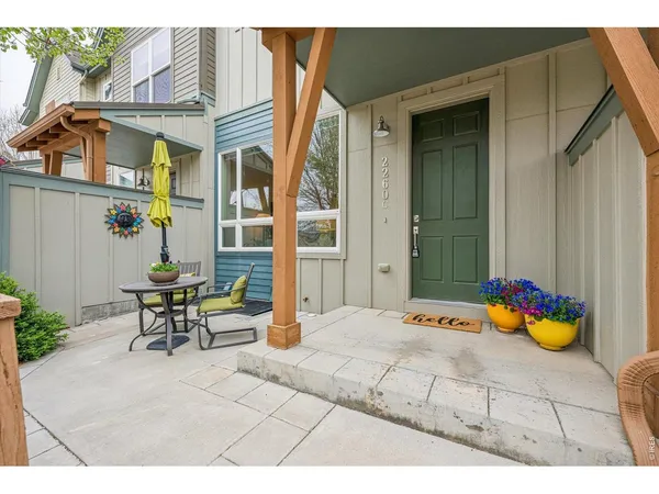 a backyard of a house with table and chairs