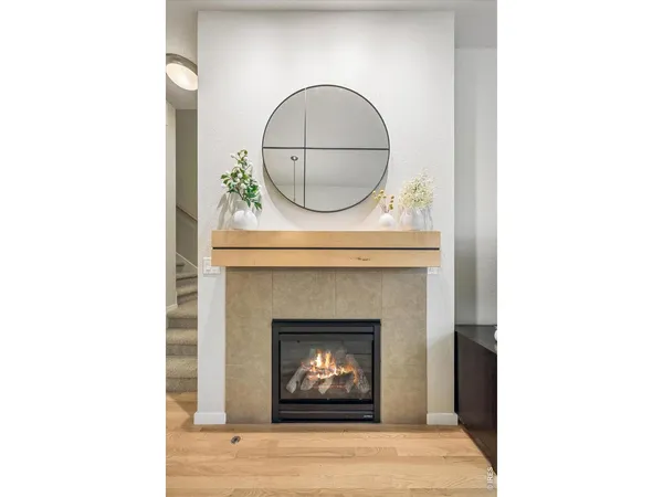 a living room with a fireplace and a rug