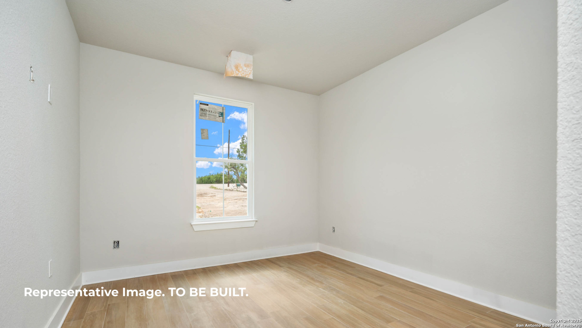 532 Restless Wind Spring Branch, TX 78070 - Photo 9 of 16 a view of an empty room with wooden floor and a window