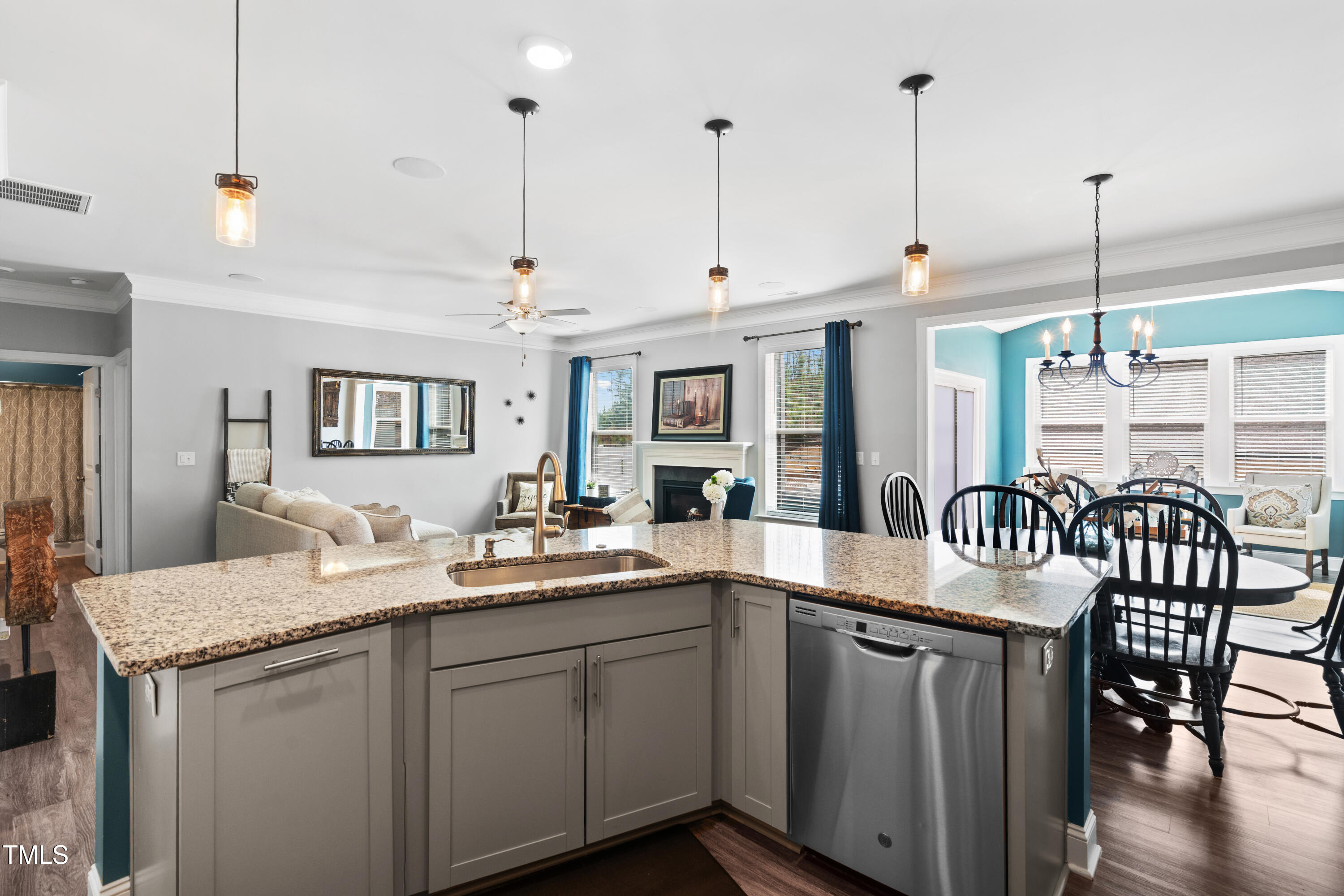 115 Cliffview Drive Garner, NC 27529 - Photo 12 of 52 a kitchen with granite countertop stainless steel appliances a table chairs sink and wooden floor