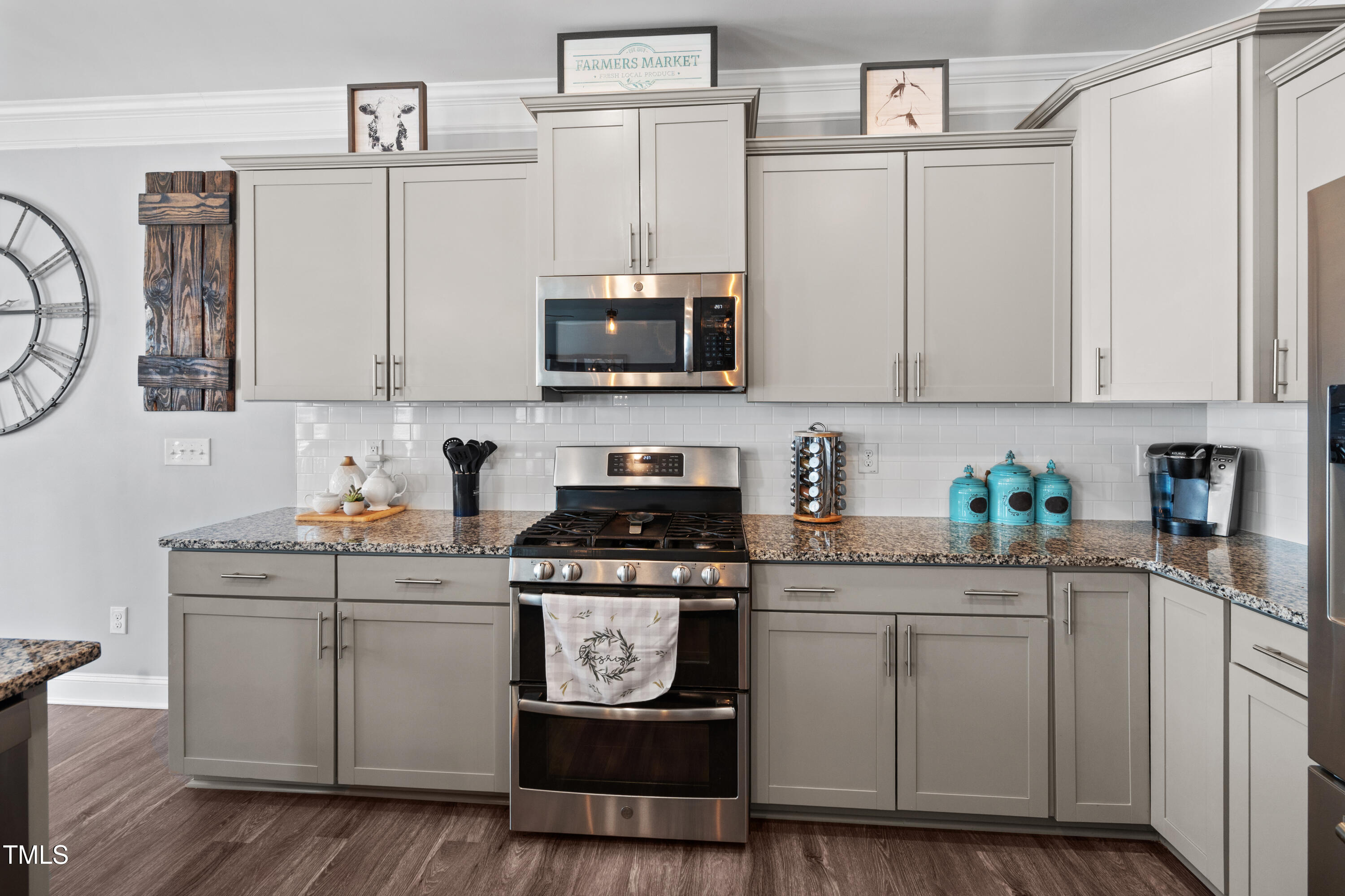 115 Cliffview Drive Garner, NC 27529 - Photo 16 of 52 a kitchen with stainless steel appliances granite countertop a stove a sink and white cabinets