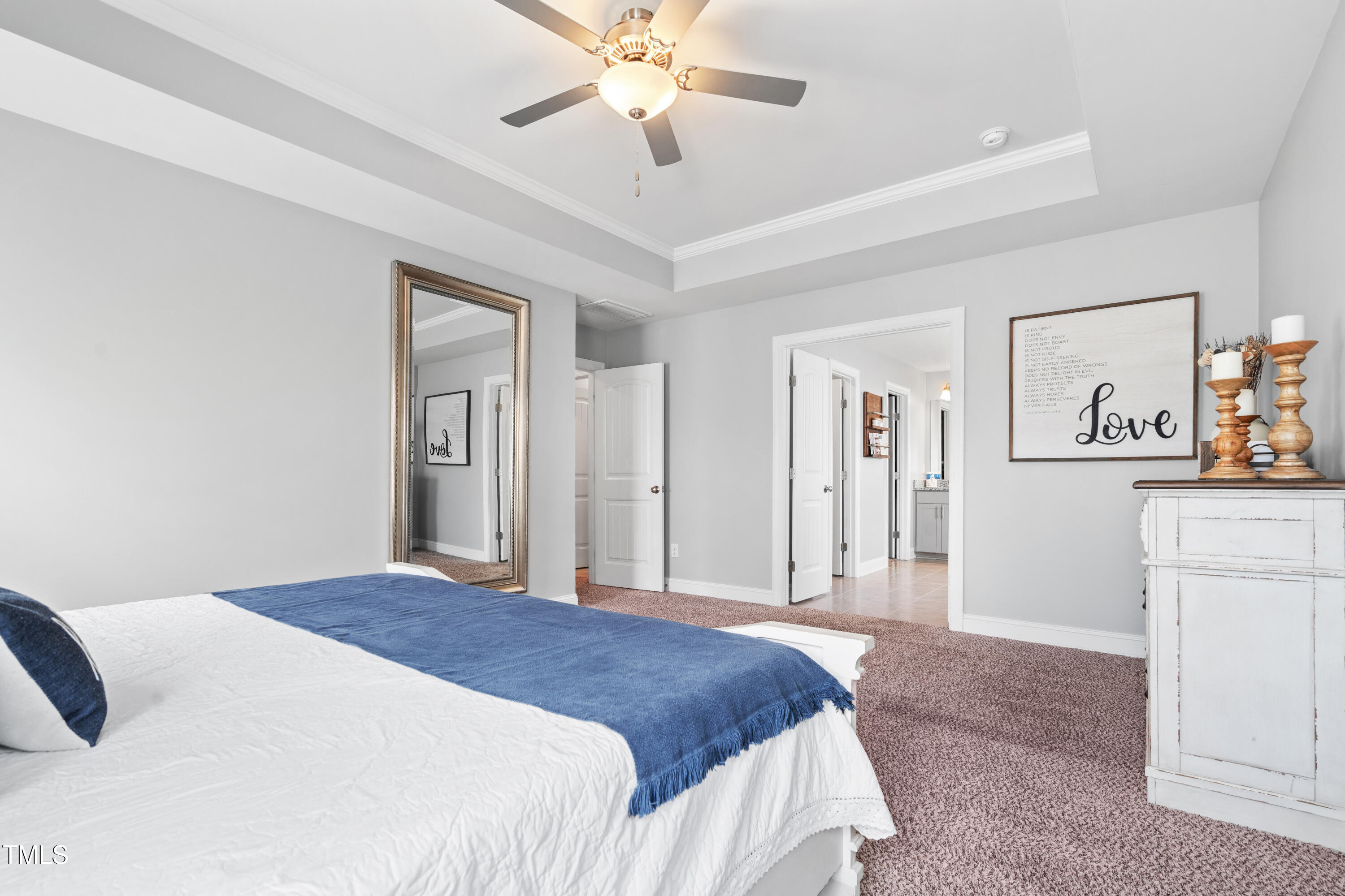 115 Cliffview Drive Garner, NC 27529 - Photo 23 of 52 a bedroom with a large bed and a chandelier