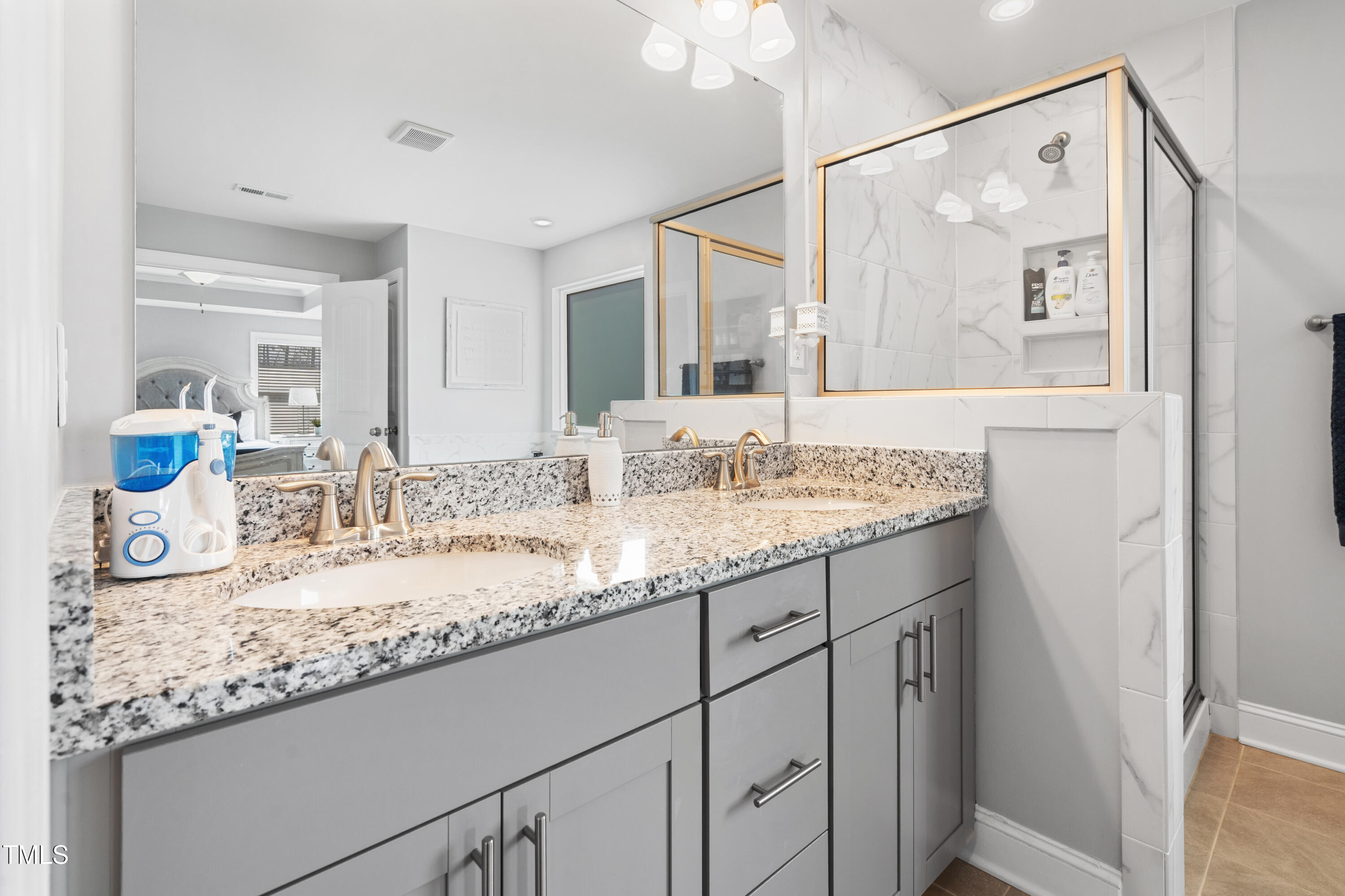 115 Cliffview Drive Garner, NC 27529 - Photo 27 of 52 a bathroom with a granite countertop sink mirror and next to a window