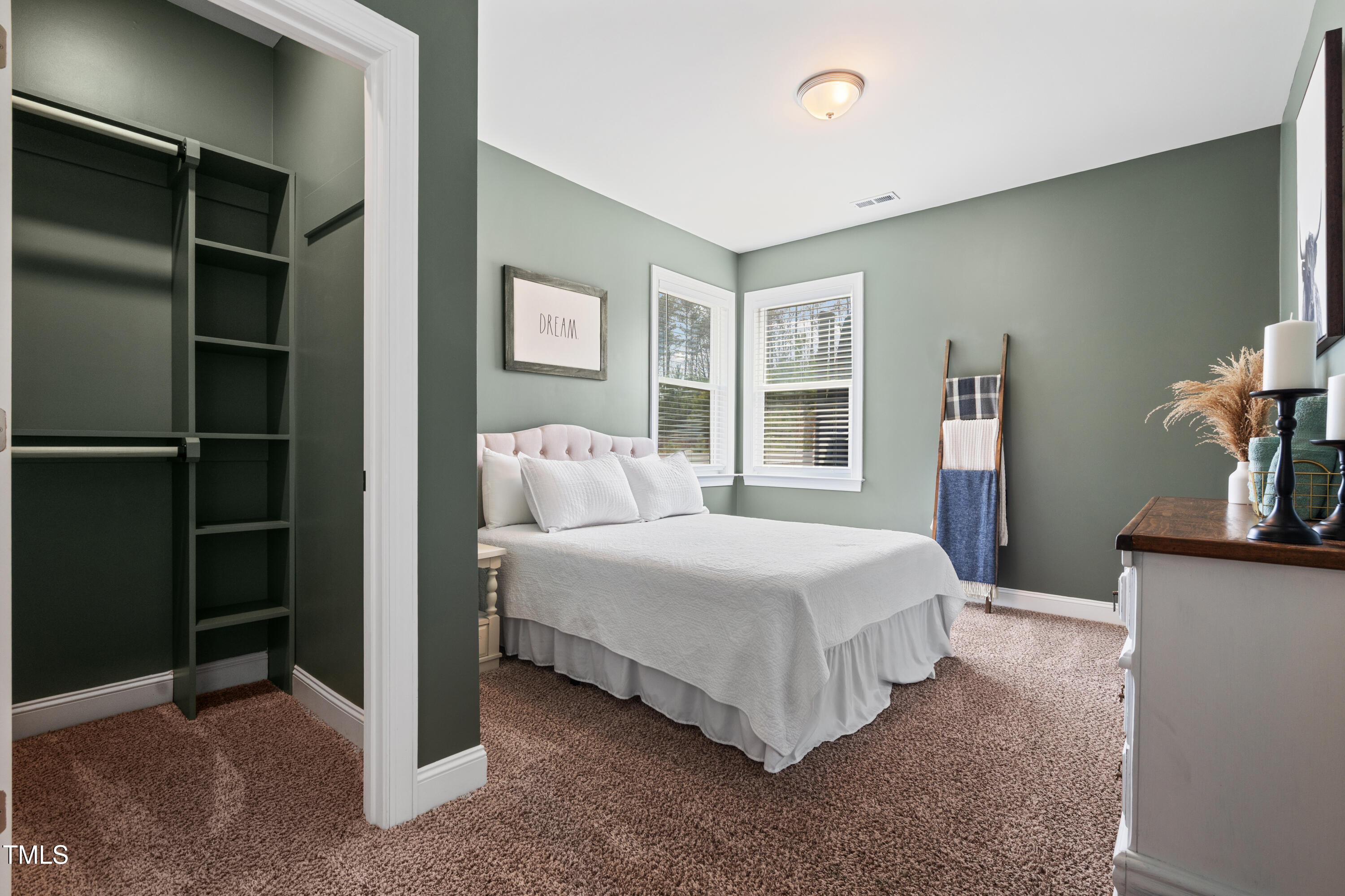 115 Cliffview Drive Garner, NC 27529 - Photo 29 of 52 a bedroom with a bed and a flat tv screen on dresser