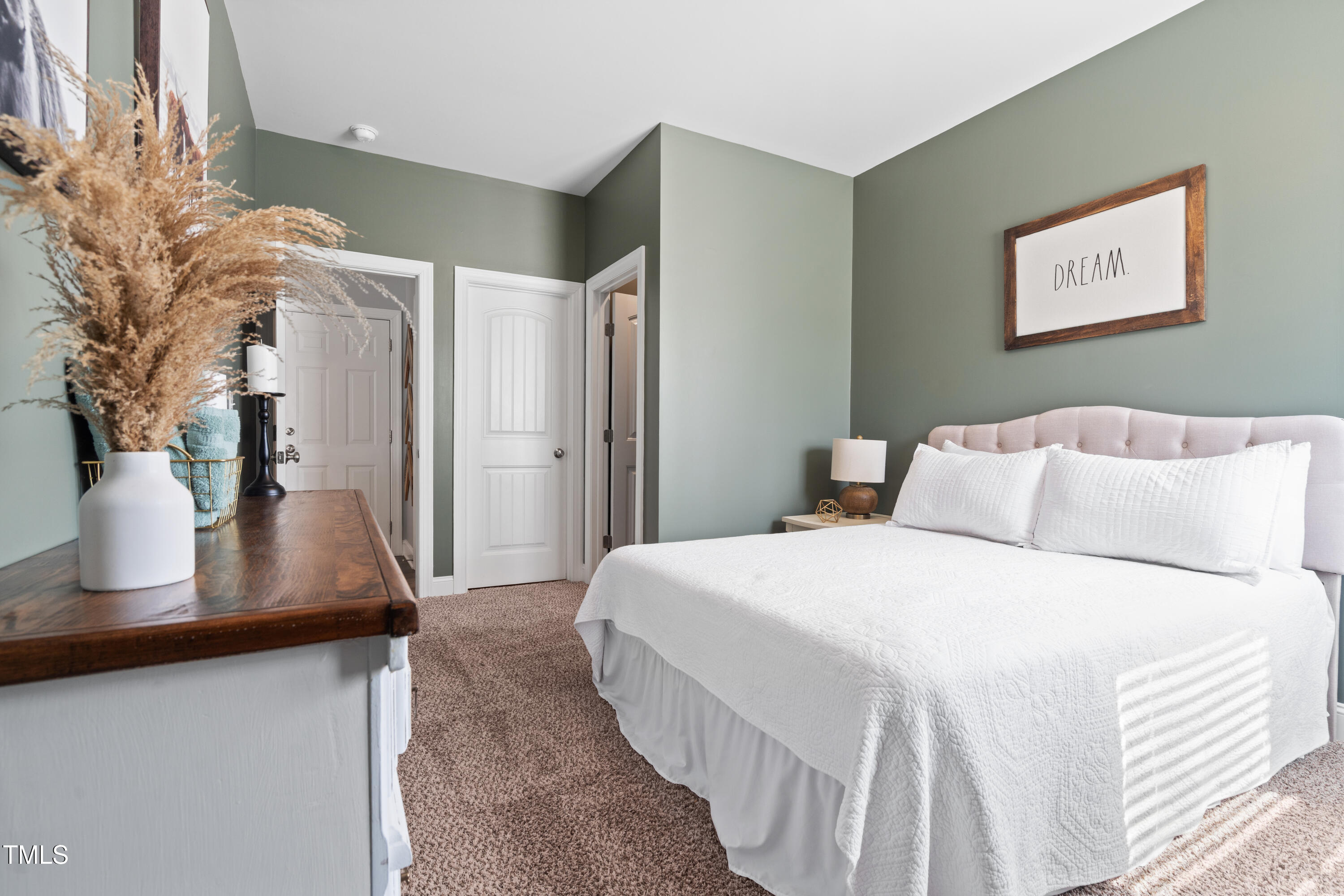 115 Cliffview Drive Garner, NC 27529 - Photo 30 of 52 a bedroom with a large bed and a potted plant