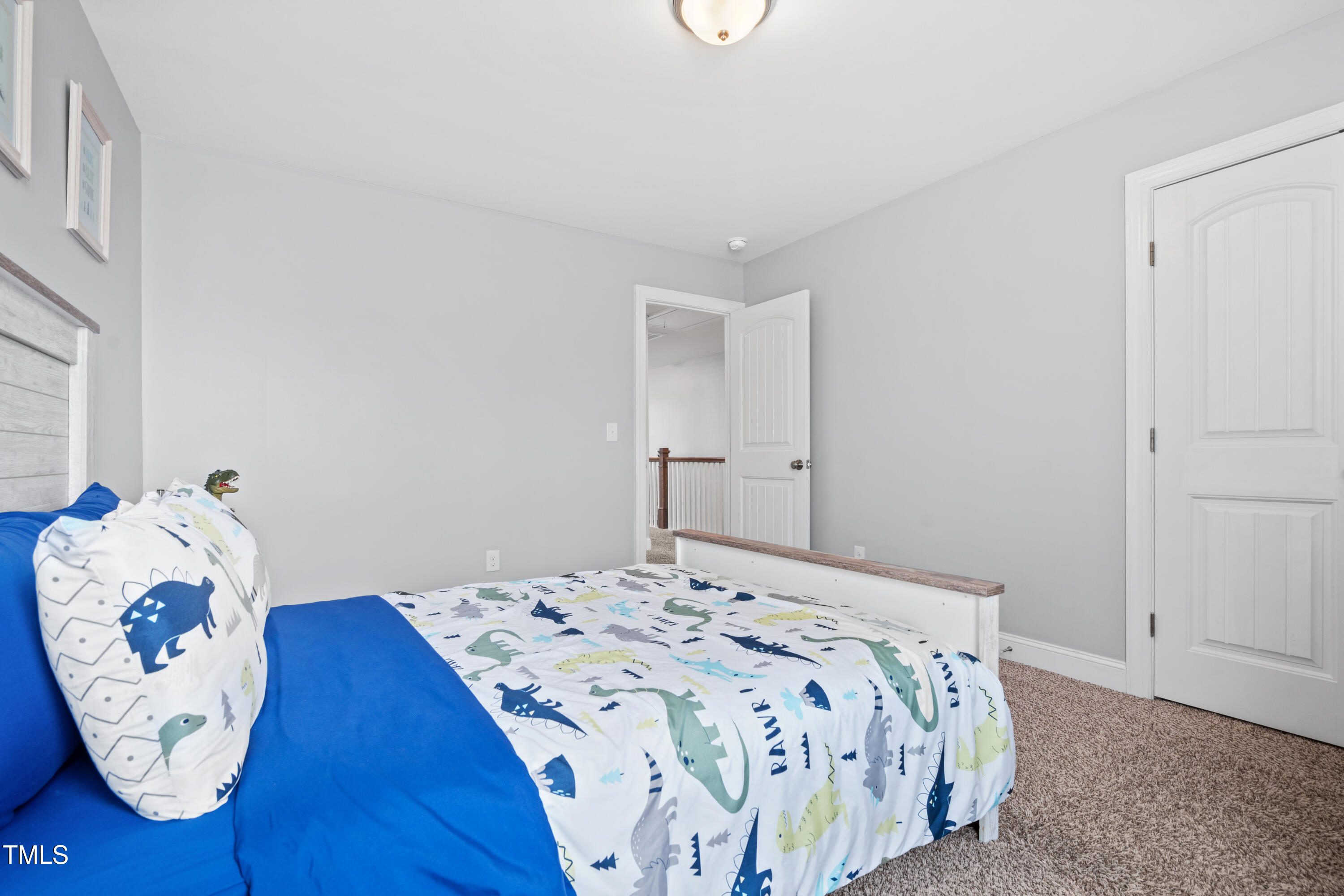 115 Cliffview Drive Garner, NC 27529 - Photo 32 of 52 a bedroom with a bed and a chair