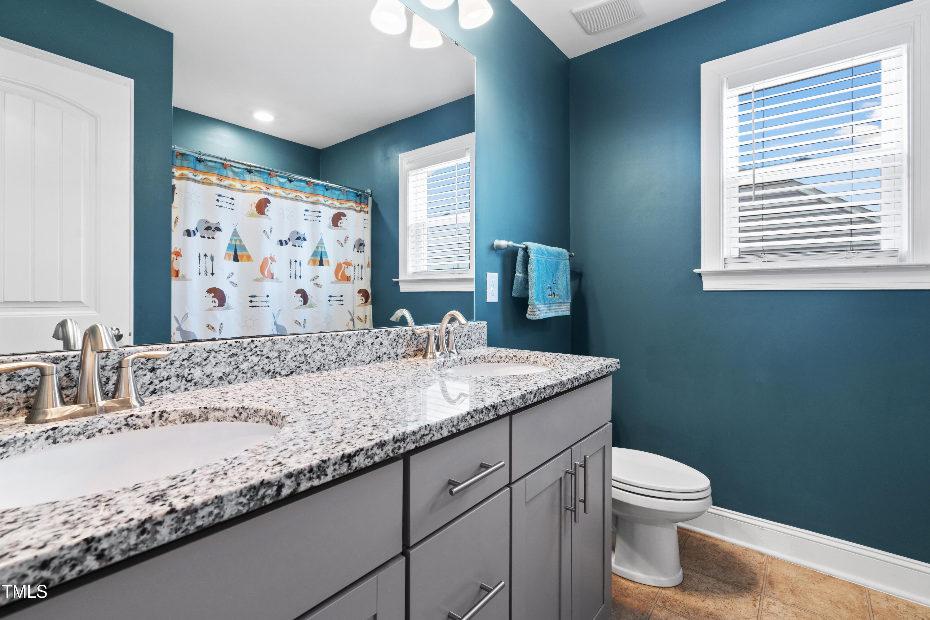 115 Cliffview Drive Garner, NC 27529 - Photo 36 of 52 a bathroom with a granite countertop sink a toilet and a large mirror