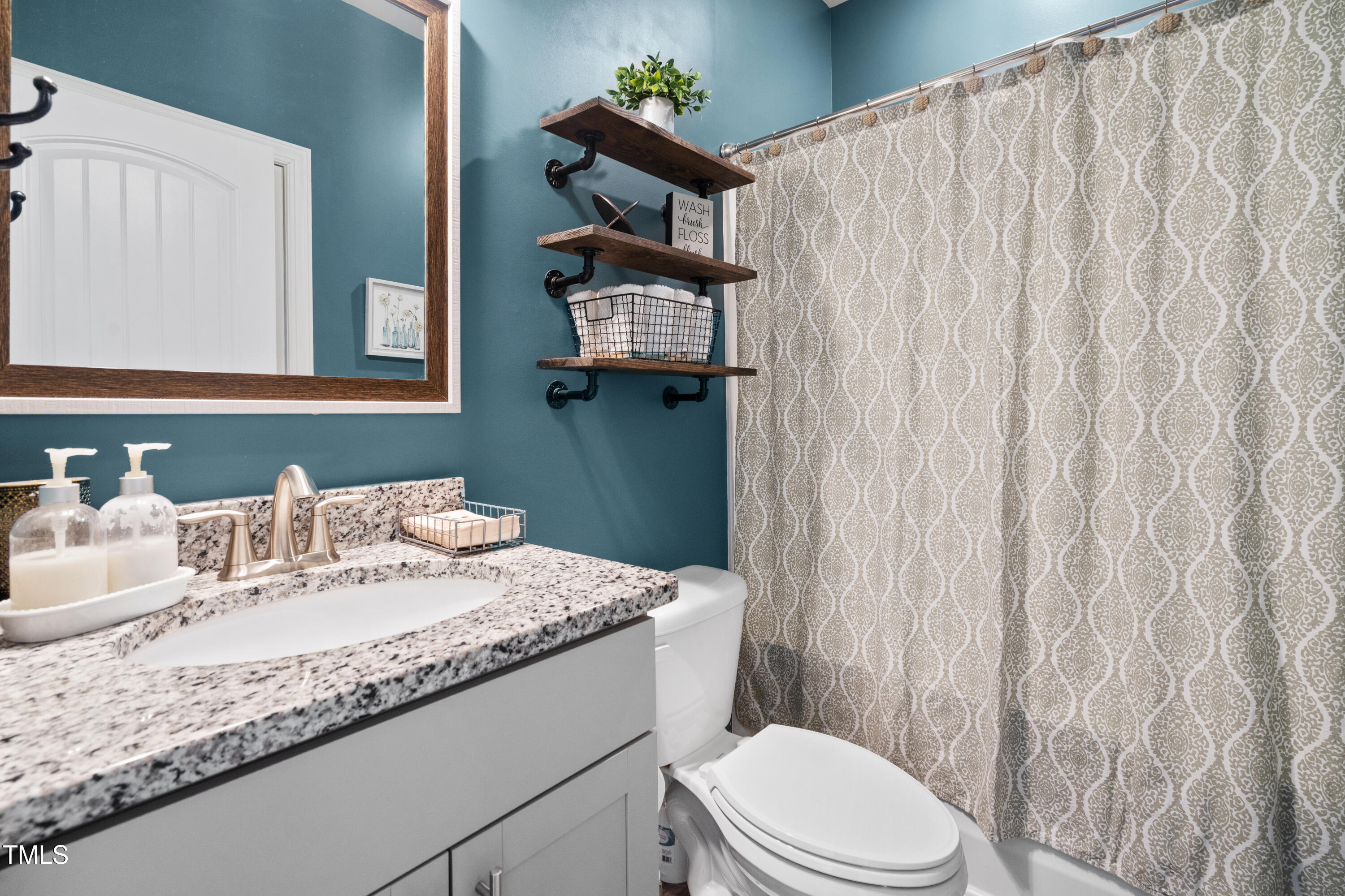 115 Cliffview Drive Garner, NC 27529 - Photo 37 of 52 a bathroom with a granite countertop sink and a mirror