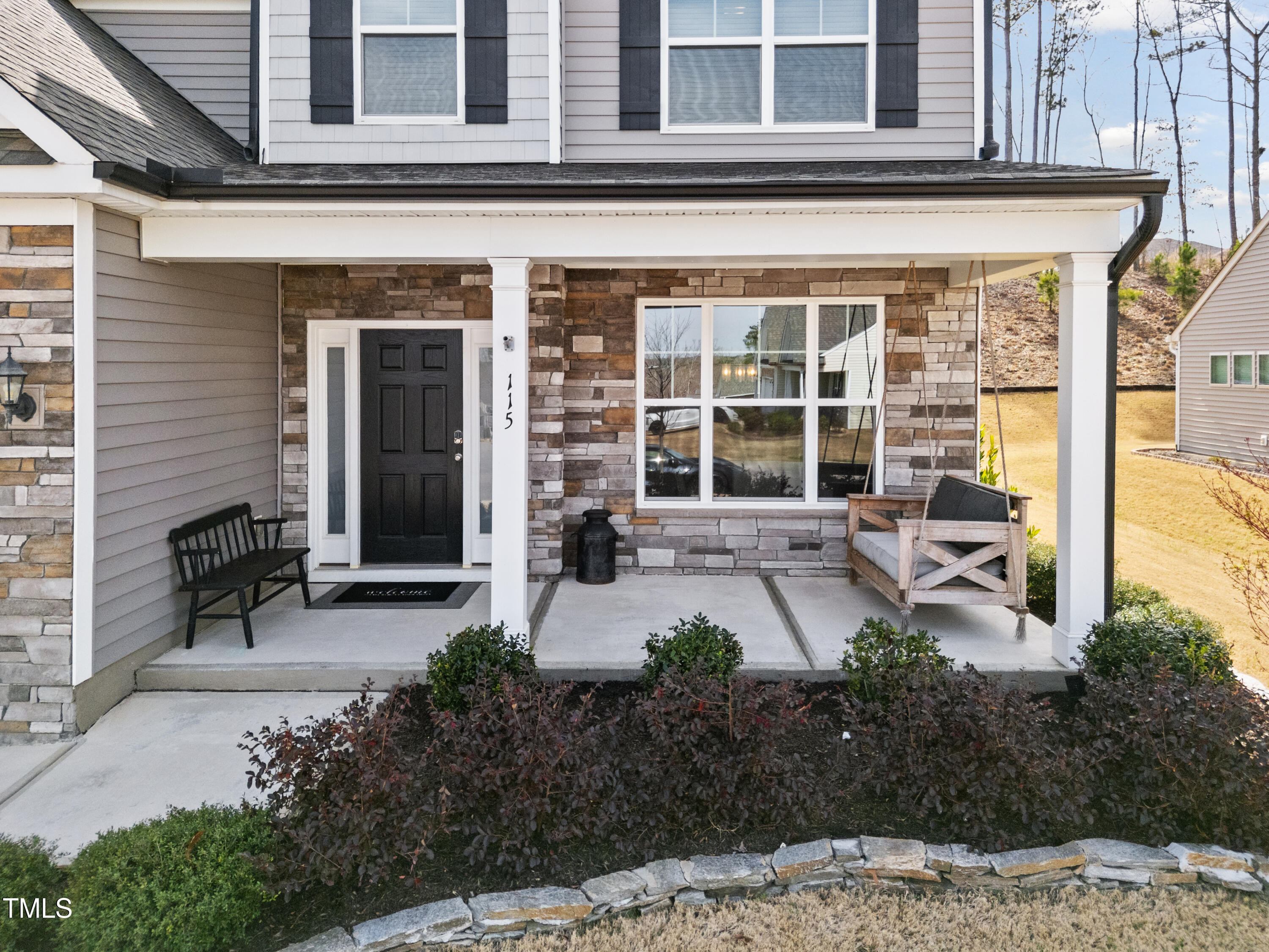 115 Cliffview Drive Garner, NC 27529 - Photo 4 of 52 a front view of a house with garden and patio