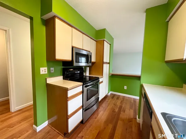 a kitchen with a sink a microwave a stove and refrigerator