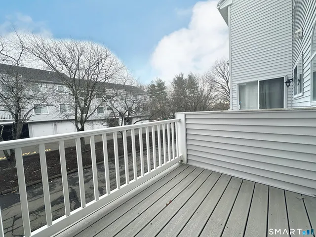 a view of a wooden balcony with wooden floor and fence