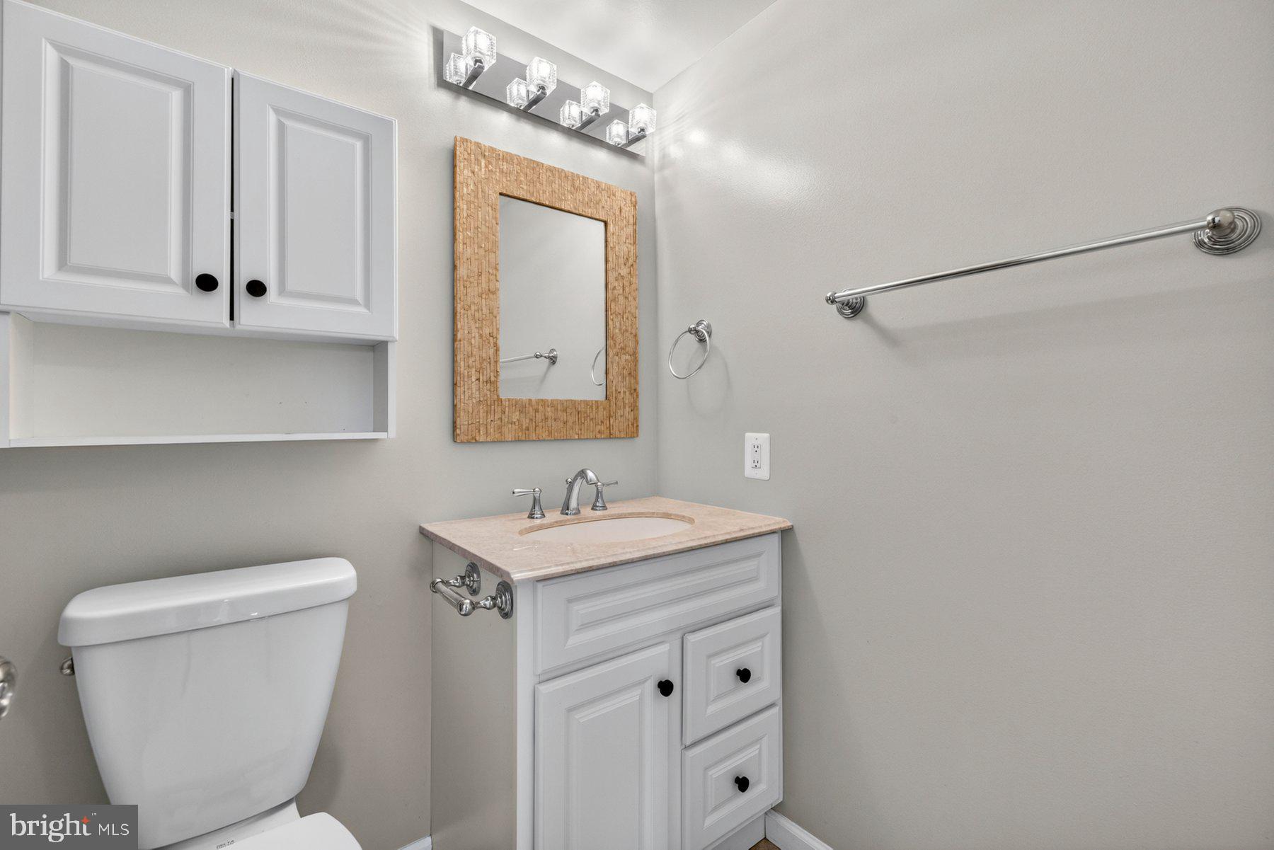 7518 Candytuft Court Springfield, VA 22153 - Photo 29 of 47 a bathroom with a toilet sink and mirror
