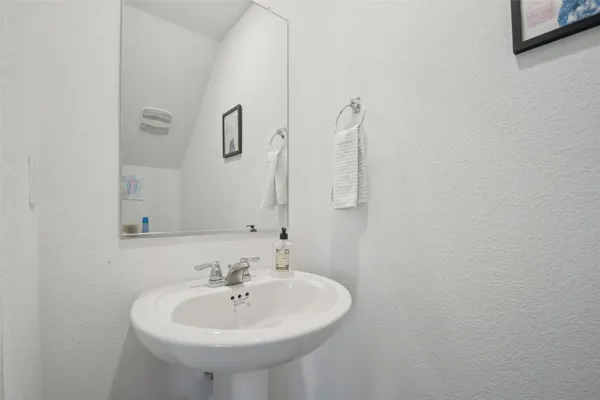 a bathroom with a sink a toilet and a mirror