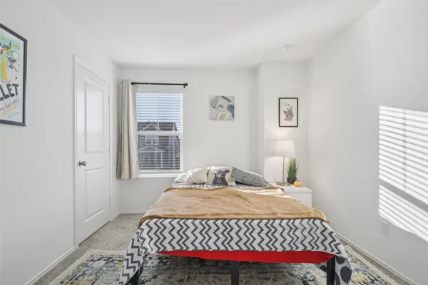a bedroom with a large bed and a large window